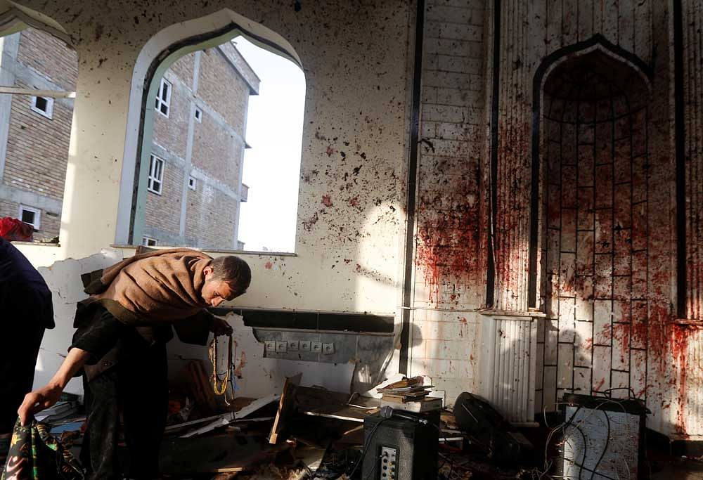 An Afghan man inspects inside a Shi'ite Muslim mosque after last night attack in Kabul, Afghanistan. Reuters Photo