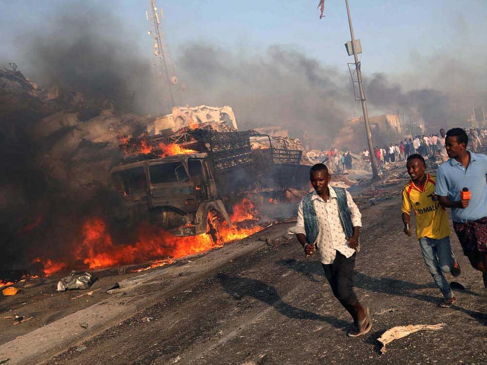Civilians evacuate from the scene of an explosion in KM4 street in the Hodan district of Mogadishu, Somalia October 14, 2017. REUTERS