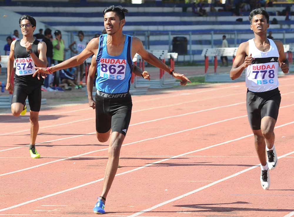 ecstatic: Devaiah of DYES (centre) wins the U-20 200M gold ahead of Gowrishankar in the BUDAA athletics meet in Bengaluru on Monday. DH photo