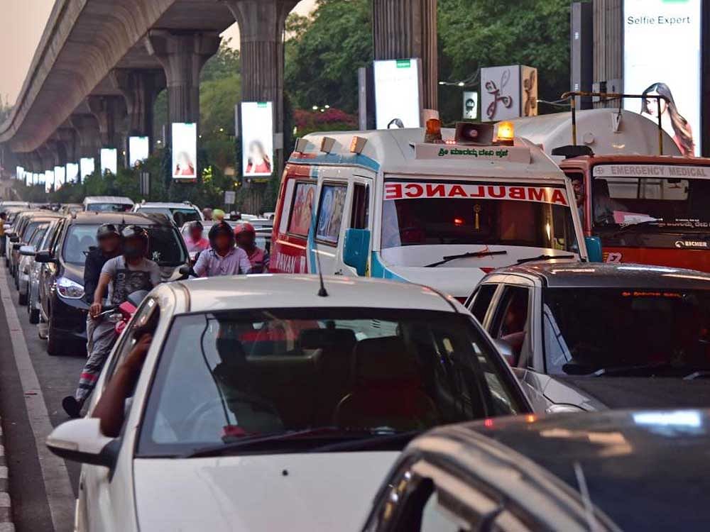 Thanks to the traffic gridlock, ambulances stuck on the roads have become a common sight in the city. DH Photo.