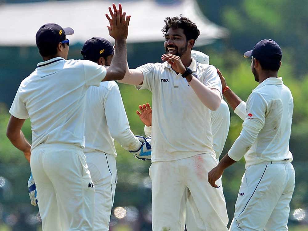 Hyderabad's Mohammed Siraj (centre) celebrates with his team-mates after scalping a Karnataka batsman on Tuesday. DH PHOTO/ RANJU P