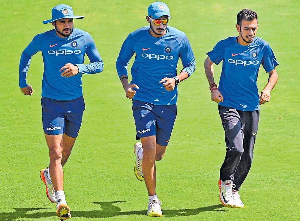 Manish Pandey, Axar Patel and Yuzvendra Chahal warm up during a practice session ahead of the second ODI on Tuesday. PTI