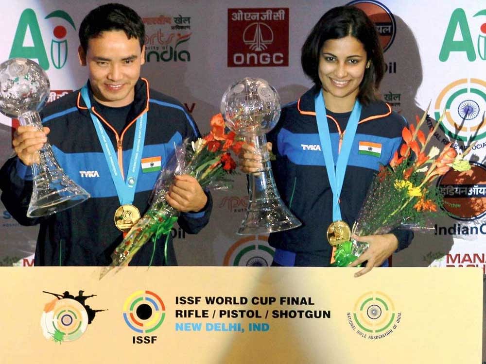 Jitu Rai (left) and Heena Sidhu with their gold medals on Monday. PTI