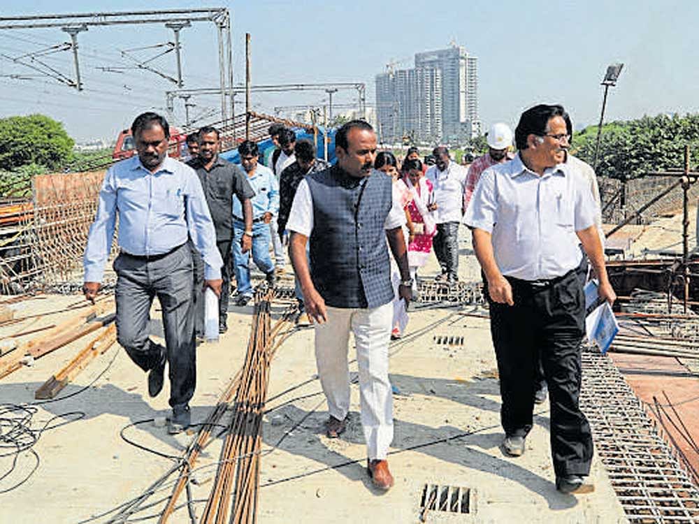 Mayor R Sampath Raj and BBMP officials inspect the work on the Okalipuram flyover on Tuesday. DH PHOTO