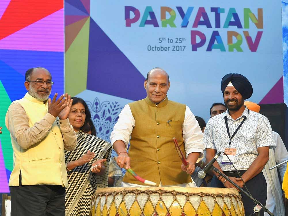 Union Home Minister Rajnath Singh beating a drum as Minister of State  for Tourism, K J Alphons looks on during the inaugural ceremony of 'Paryatan Parv : Grand Finale' on the Rajpath Lawns in New Delhi on Monday. PTI Photo