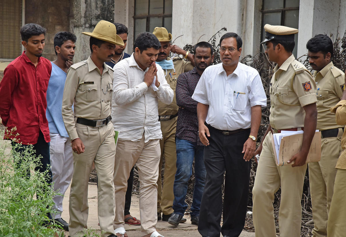 Relatives of Abdul Karim Telgi, kingpin of fake stamp paper scam is died on Thursday, are discussing with Magistrate Hattikal Prabhu Siddappa, 56 ACMM Court before receiving Telgi body at Victoria Hospital in Bengaluru on Friday. Photo by S K Dinesh