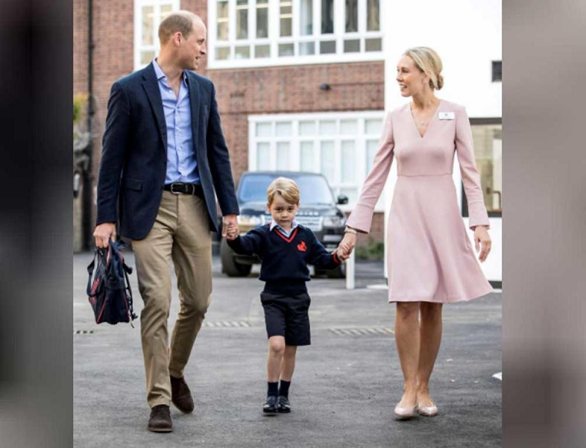 Britain's Prince William holds Prince George's hands as he arrives for his first day of school