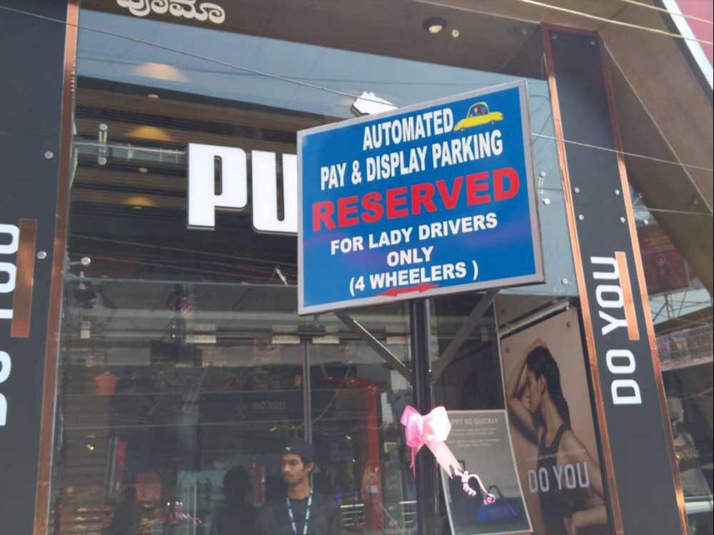 A board shows the first automated pay and park reserved for women drivers on Brigade Road in Bengaluru. DH PHOTO