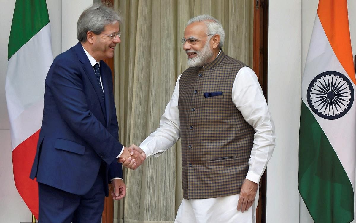 Prime Minister Narendra Modi shakes hands with his Italian counterpart Paolo Gentiloni prior to their luncheon talks at Hyderabad House in New Delhi on Monday. PTI Photo