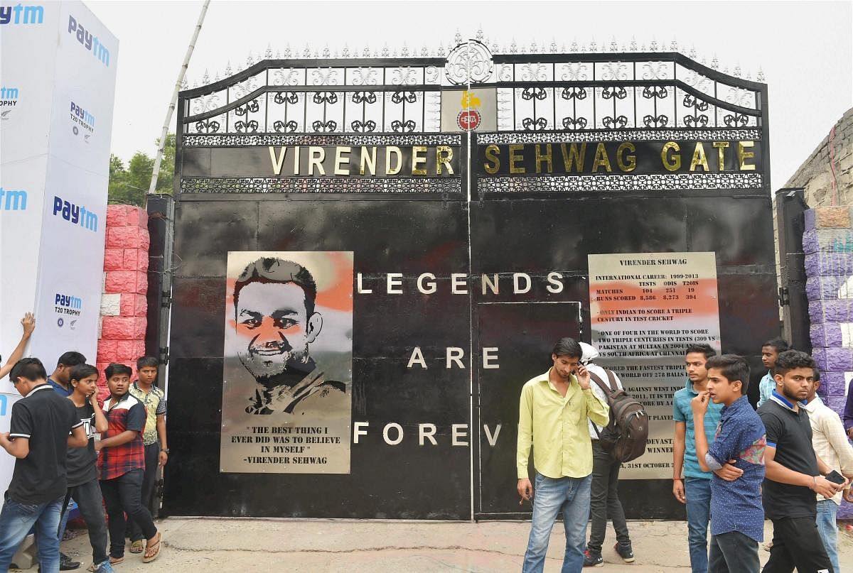 New Delhi: Cricket fans in front of Virender Sehwag Gate at the Ferozshah Kotla stadium after its inauguration in New Delhi on Tuesday. PTI Photo by Shahbaz Khan (PTI10_31_2017_000147b)