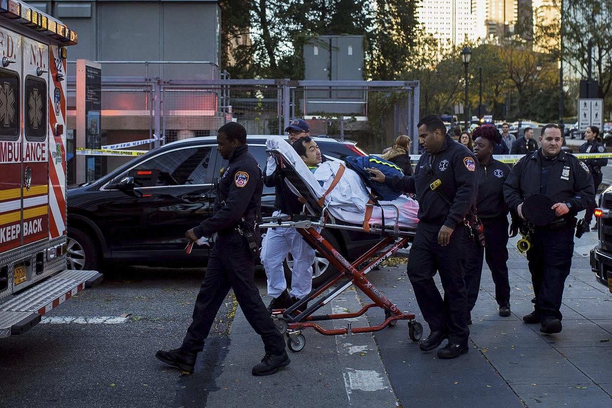 Emergency personnel carry a man into an ambulance after a motorist drove onto a busy bicycle path near the World Trade Center memorial and struck several people Tuesday, Oct. 31, 2017, in New York. AP/PTI