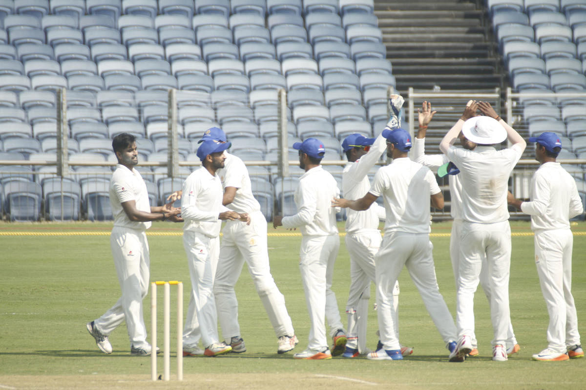 Karnataka players celebrate after skipper R Vinay Kumar scalps a Maharashtra batsman during their Ranji Trophy tie in Pune on Wednesday.