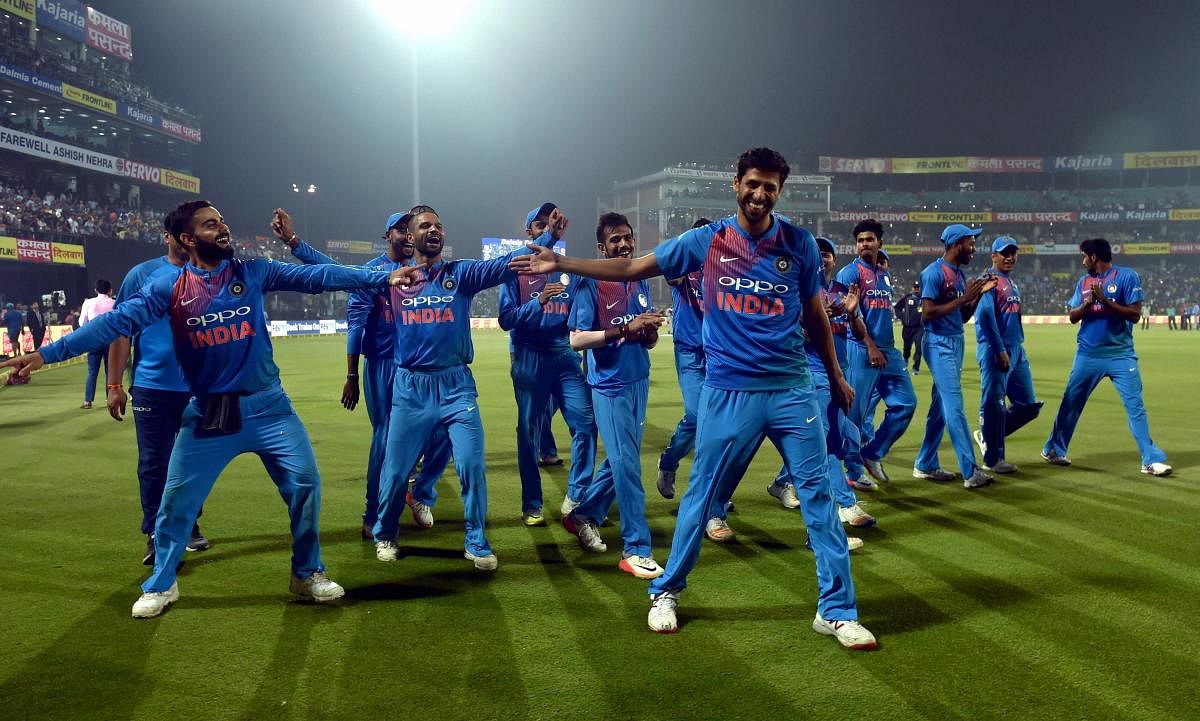 India's Ashish Nehra with teammates Virat Kohli and Shikhar Dhawan dance after his retirement from all forms of cricket during the first T20 match against New Zealand at Feroz Shah Kotla Stadium in New Delhi, on Wednesday. PTI file photo.