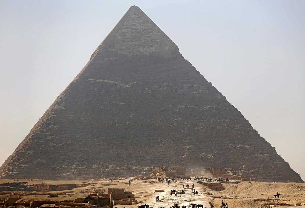 Tourists visit the Pyramid of Khufu, the largest of the Great Pyramids of Giza, on the outskirts of Cairo, Egypt. Reuters file photo.