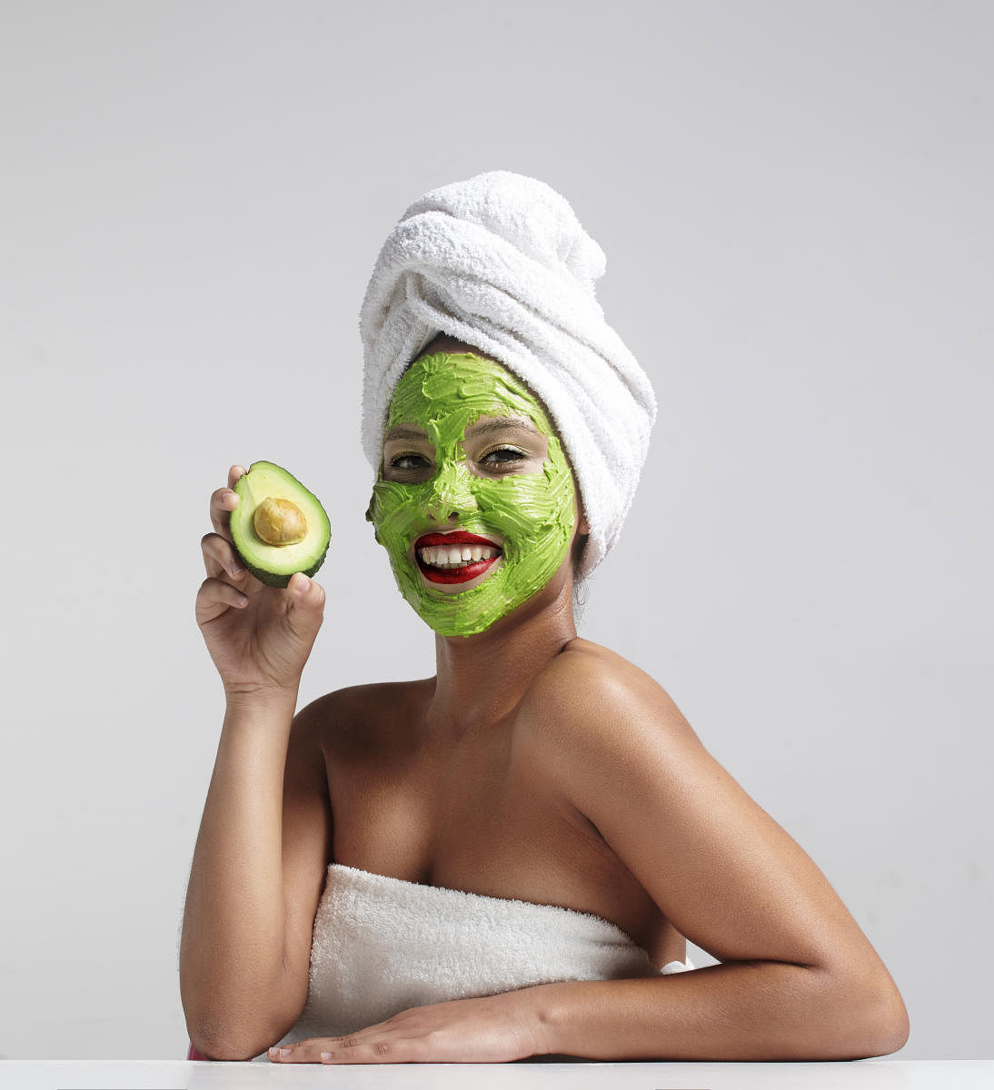 pretty woman with an avocado facial mask