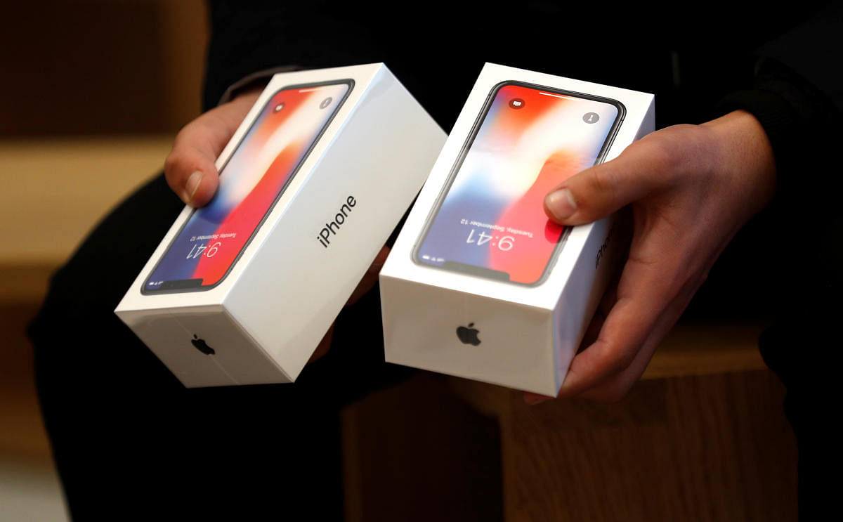 A man holds two boxes for the Apple's new iPhone X which went on sale today, at the Apple Store in Regents Street in London, Britain, November 3, 2017. REUTERS/Peter Nicholls