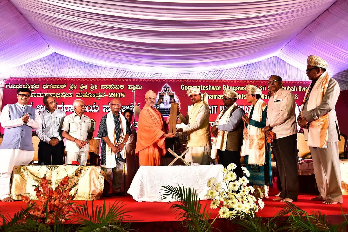Union Minister Ananth Kumar displays 'Gomatasara' work of Nemichandra as mark of inauguration of international Prakrit Conference, in Shravanabelagola, on Friday.