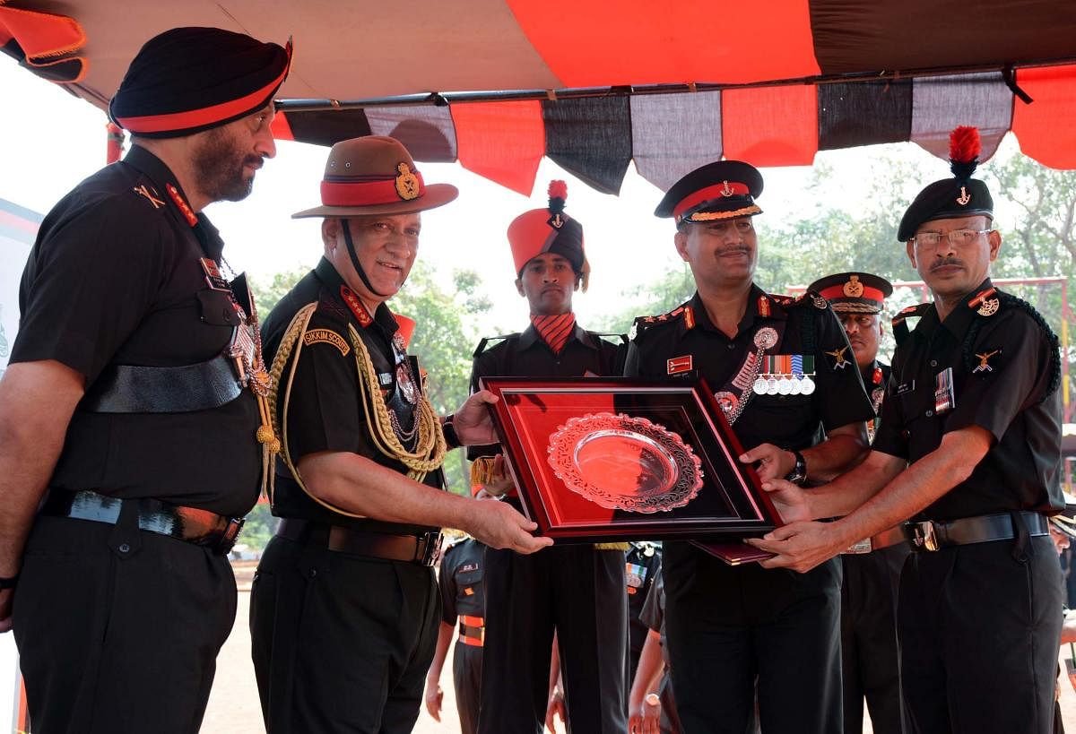 Chief of Army Staff General Bipin Rawat presenting commendation cards in recognition of distinguished services rendered by select officers and other ranks after President's Colours presentation to two battalions of Maratha Light Infantry, 23 Maratha LI and 24 Maratha LI at Maratha Light Infantry Regimental Centre (MLIRC), in Belagavi, on Friday. DH Photo