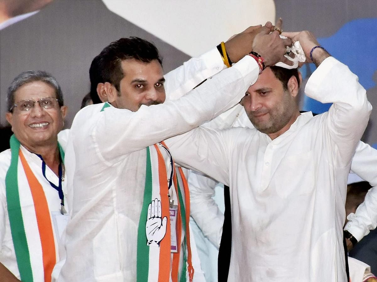 Surat: Congress vice-president Rahul Gandhi being welcome by party worker during a public meet for gujarat elections campaign at Varachha in Surat on Friday.