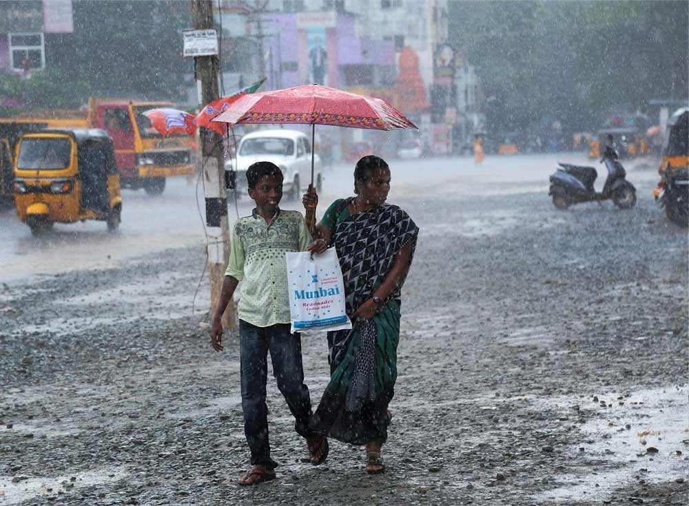 A woman and a boy walk under an umbrella during heavy rains in Nagercoil, Tamil Nadu on Saturday. PTI Photo