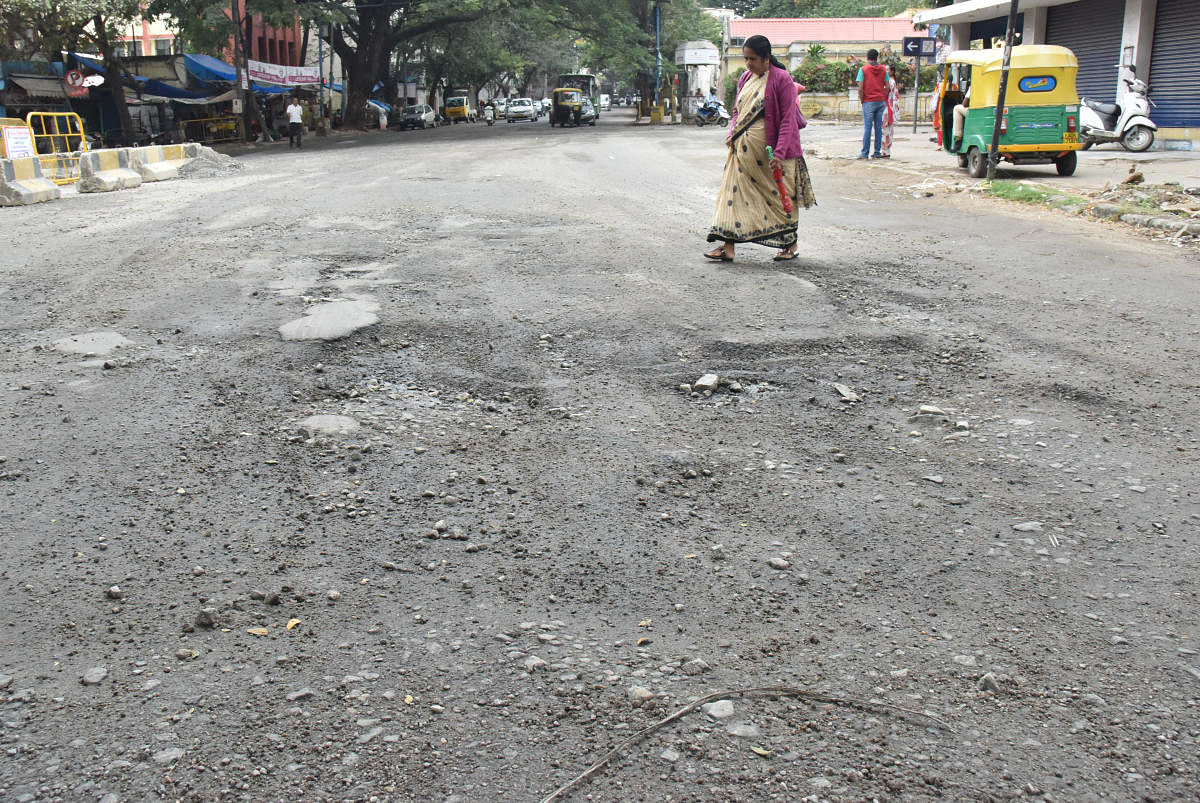 Badly damaged road seen at Sree M G Shesadri circle in Bengaluru on Sunday. Photo by Janardhan B K