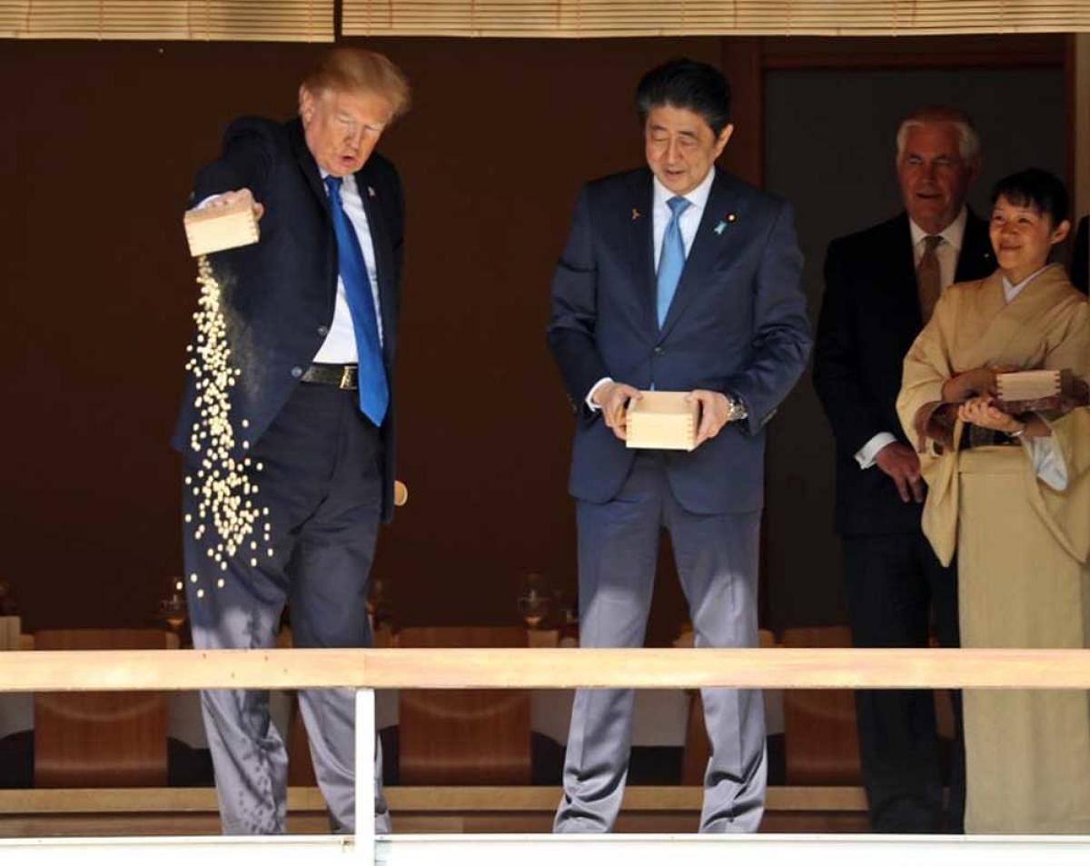 Donald Trump emptying a box of food into a pond of koi carp has resulted in criticism from people, who say the carps are delicate. twitter photo.