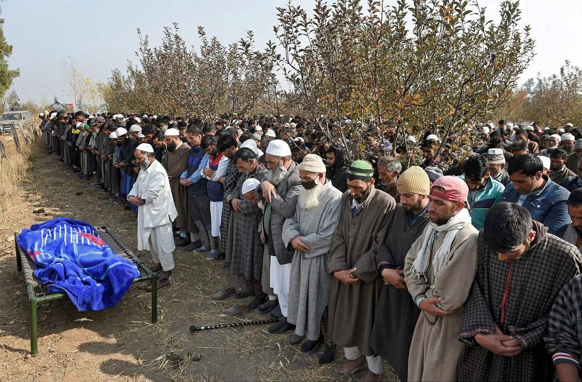 People offer funeral prayers of police constable Abdul Salaam at Chanch Marg in Shopian of South Kashmir on Sunday. One policeman was killed and another injured in a militant attack at Rajpora in Pulwama District Yesterday. PTI Photo