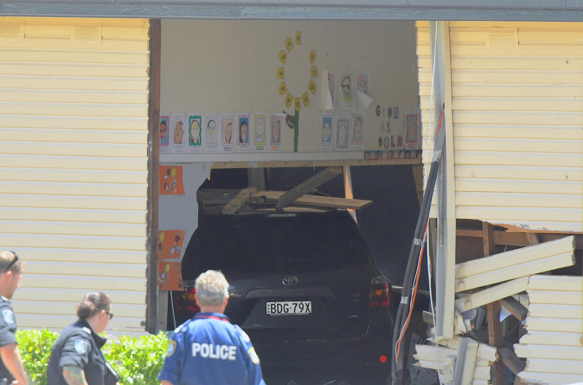 New South Wales emergency services personnel and police look at a vehicle that crashed into a primary school classroom in the Sydney suburb of Greenacre in Australia, November 7, 2017. Reuters photo