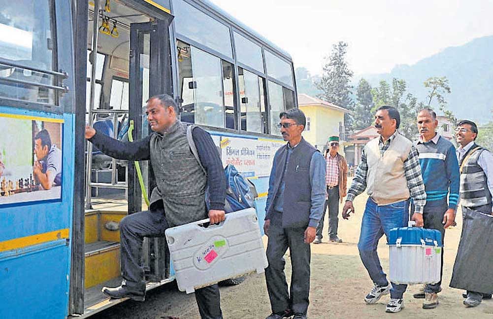 Officials leave for polling stations from Mandi in Himachal Pradesh, on Tuesday, marking an end to campaigning in the hill state . The Election Commission said exit poll results cannot be made public before December 14 evening. PTI