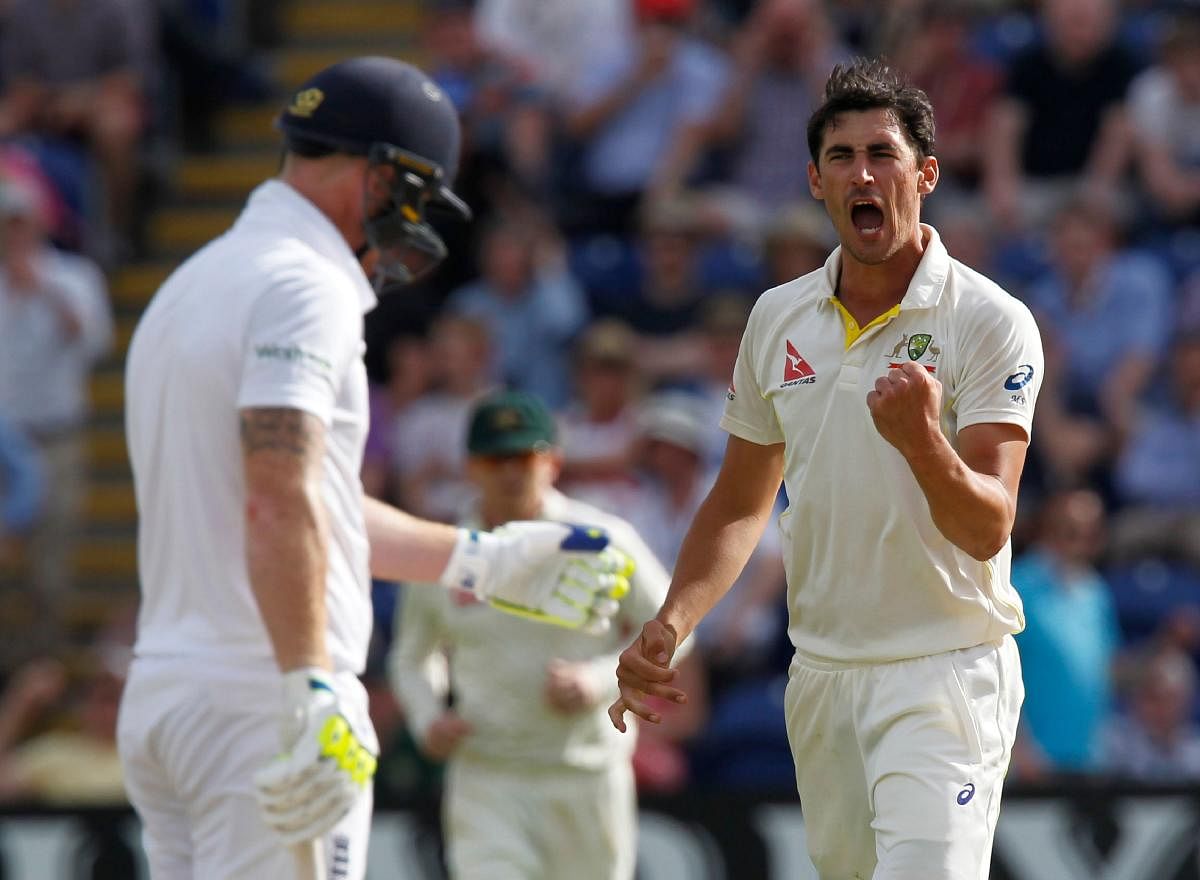(FILES) A file photo taken on July 8, 2015, shows Australia's Mitchell Starc (R) celebrating bowling England's Ben Stokes (L) during play on the third day of the opening Ashes cricket test match in Cardiff, south Wales. Fast bowler Mitchell Starc has urged Australian fans to