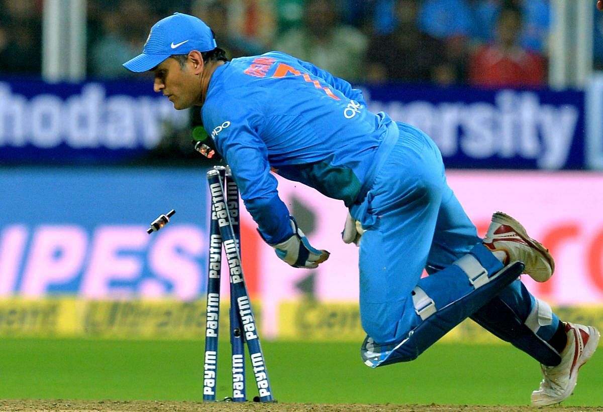 M S Dhoni runs-out New Zealand batsman Tom Bruce during the final T20 in Thiruvananthapuram on Tuesday. AFP