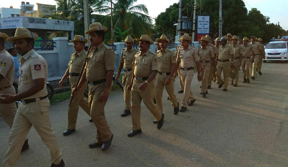 Police take out a flag march ahead of Tipu Jayanti in Maddur town on Thursday.