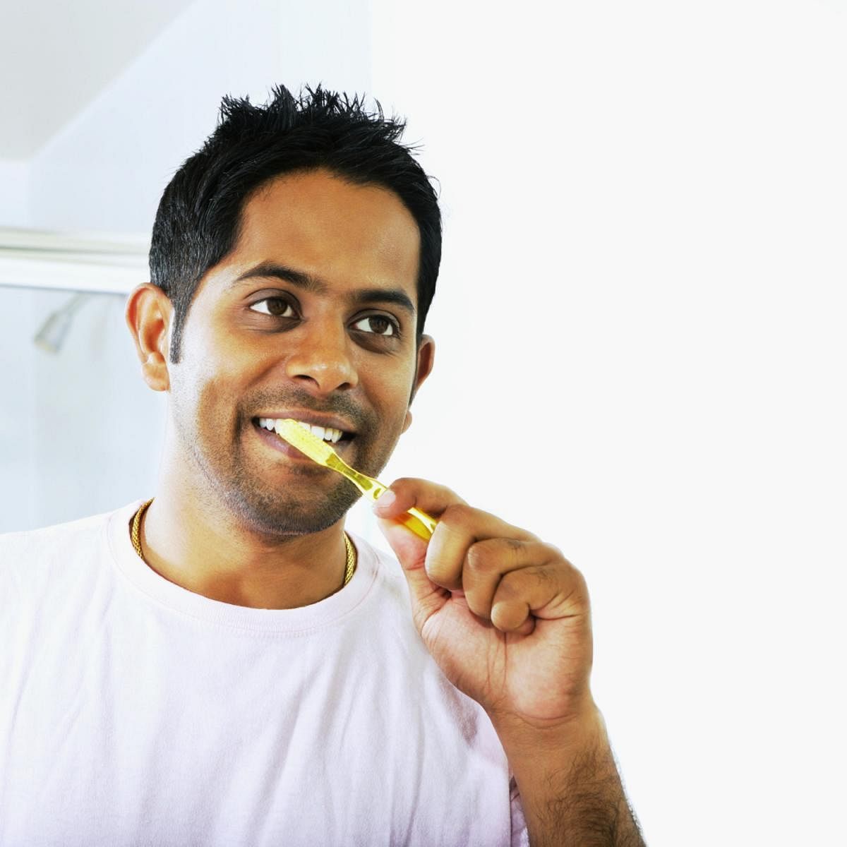 Close-up of a young man brushing his teethGum health