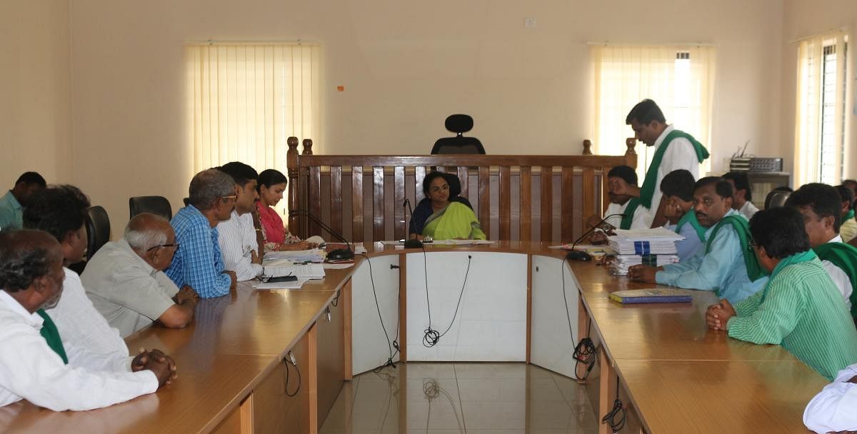 Additional deputy commissioner K N Anuradha and farmers' leaders at a meeting on fixing compensation for land acquired for high-tension power line, in Chikkaballapur. DH Photo