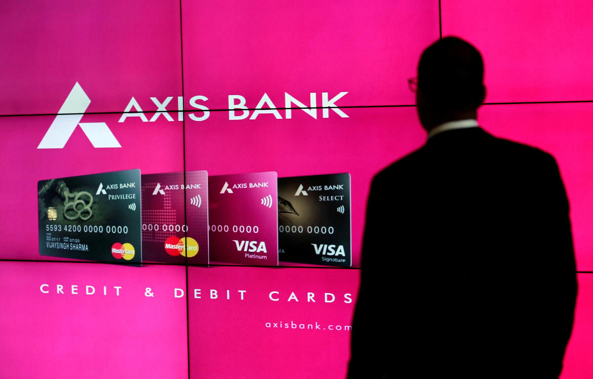 A visitor watches an Axis Bank's advertisement at its corporate headquarters in Mumbai.