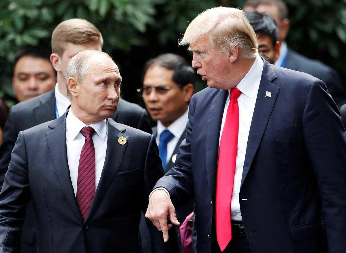 U.S. President Donald Trump and Russia's President Vladimir Putin talk during the family photo session at the APEC Summit in Danang, Vietnam November 11, 2017. REUTERS