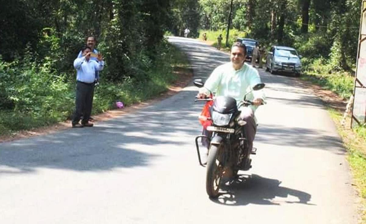 Udupi District-In-charge Minister Pramod Madhwaraj riding a two-wheeler without wearing helmet, in Udupi.