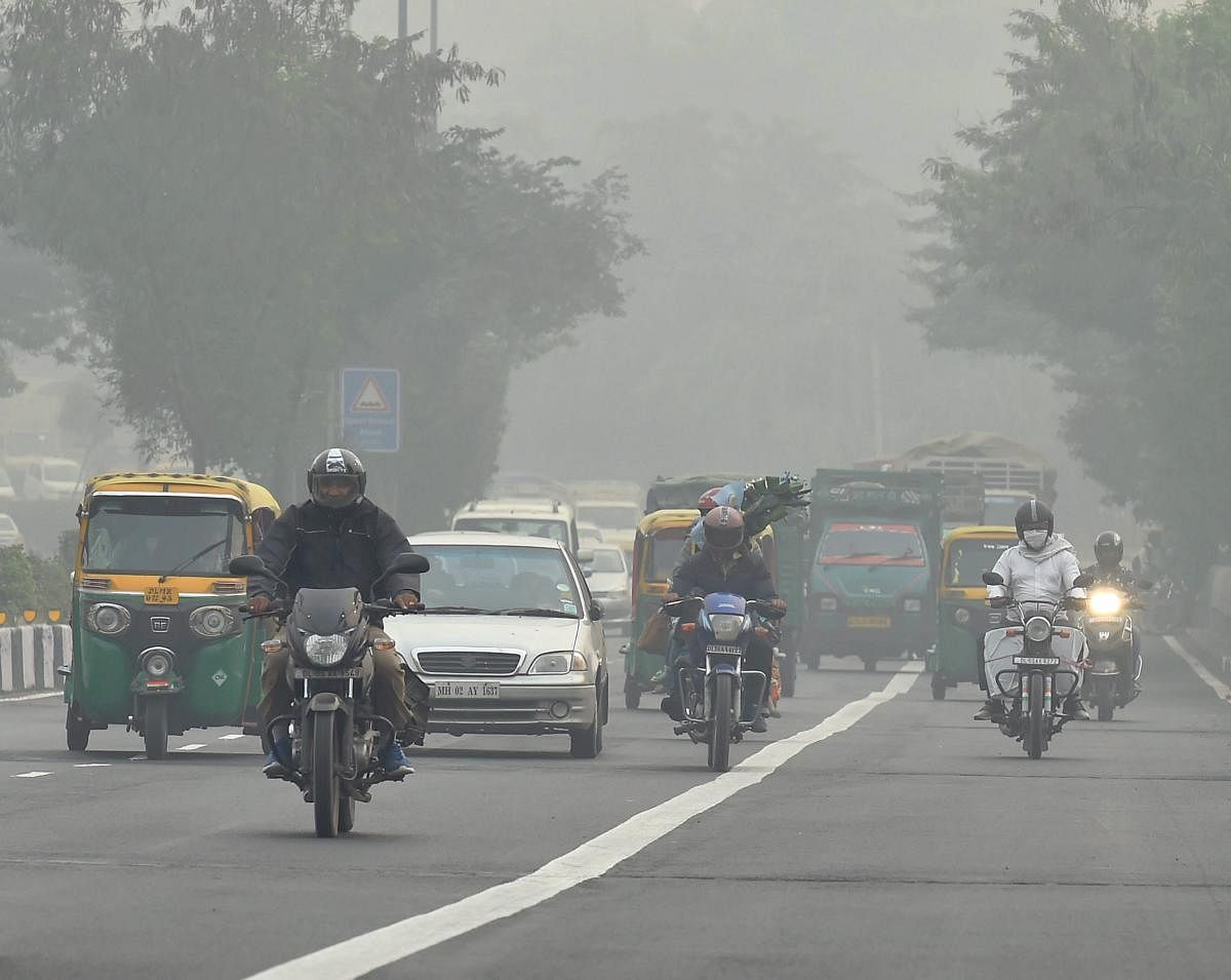 People commute on a foggy day in New Delhi on Saturday.PTI
