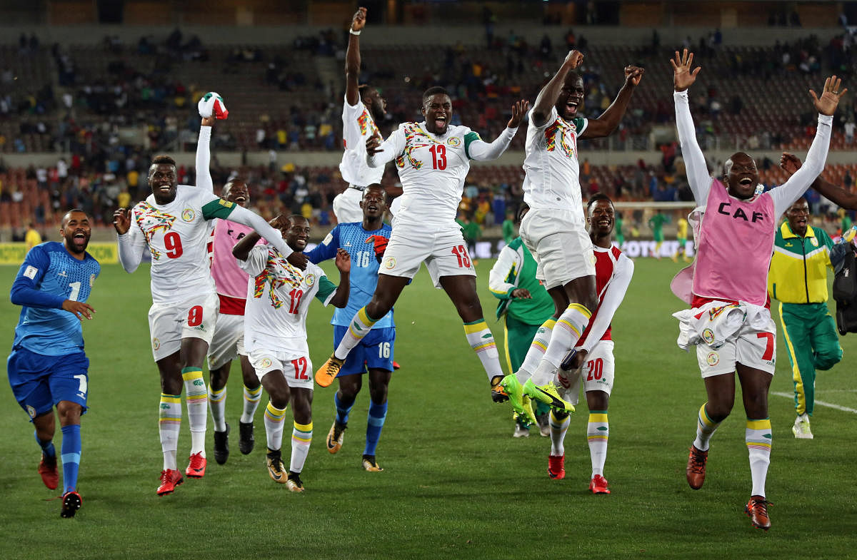 Senegalese players celebrate after sealing their place in next year's FIFA World Cup at the Peter Mokaba Stadium in Polokwane, South Africa on Saturday. Reuters