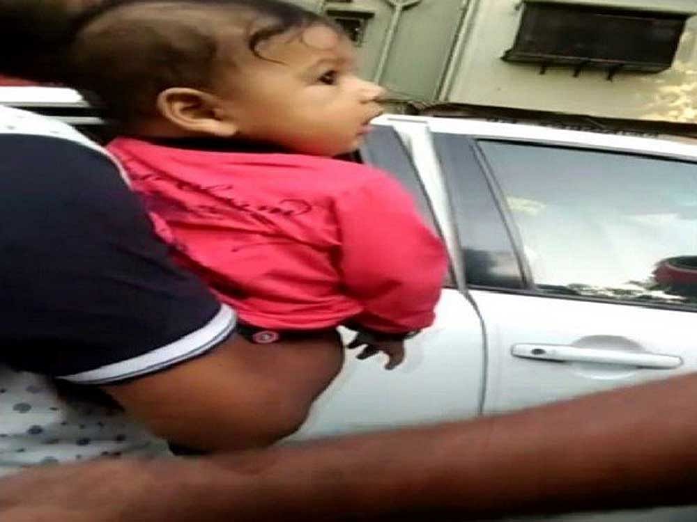 The infant was moved inside the car later, indicating that the situation could have been averted by the parent. Image courtesy ANI/Twitter