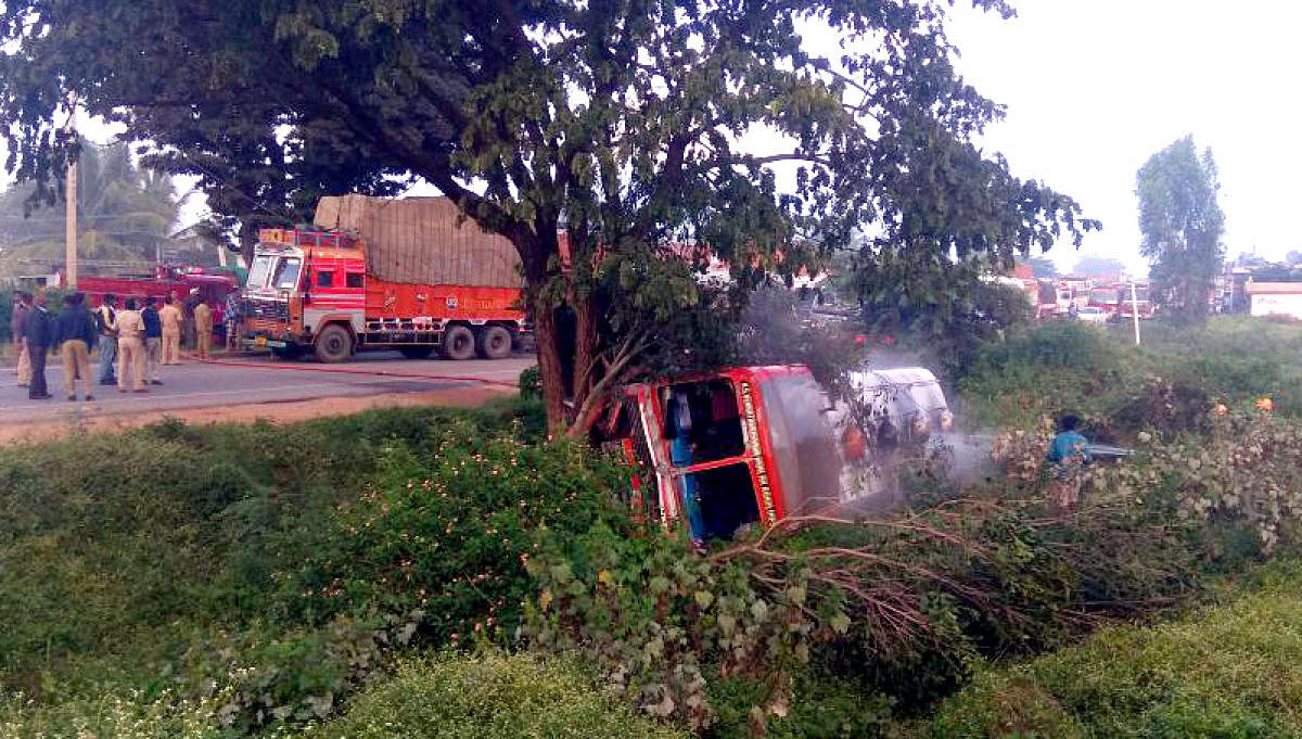 A tanker carrying chemical toppled into a ditch and caught fire on NH-4 near Nelamangala on Sunday morning. DH Photo