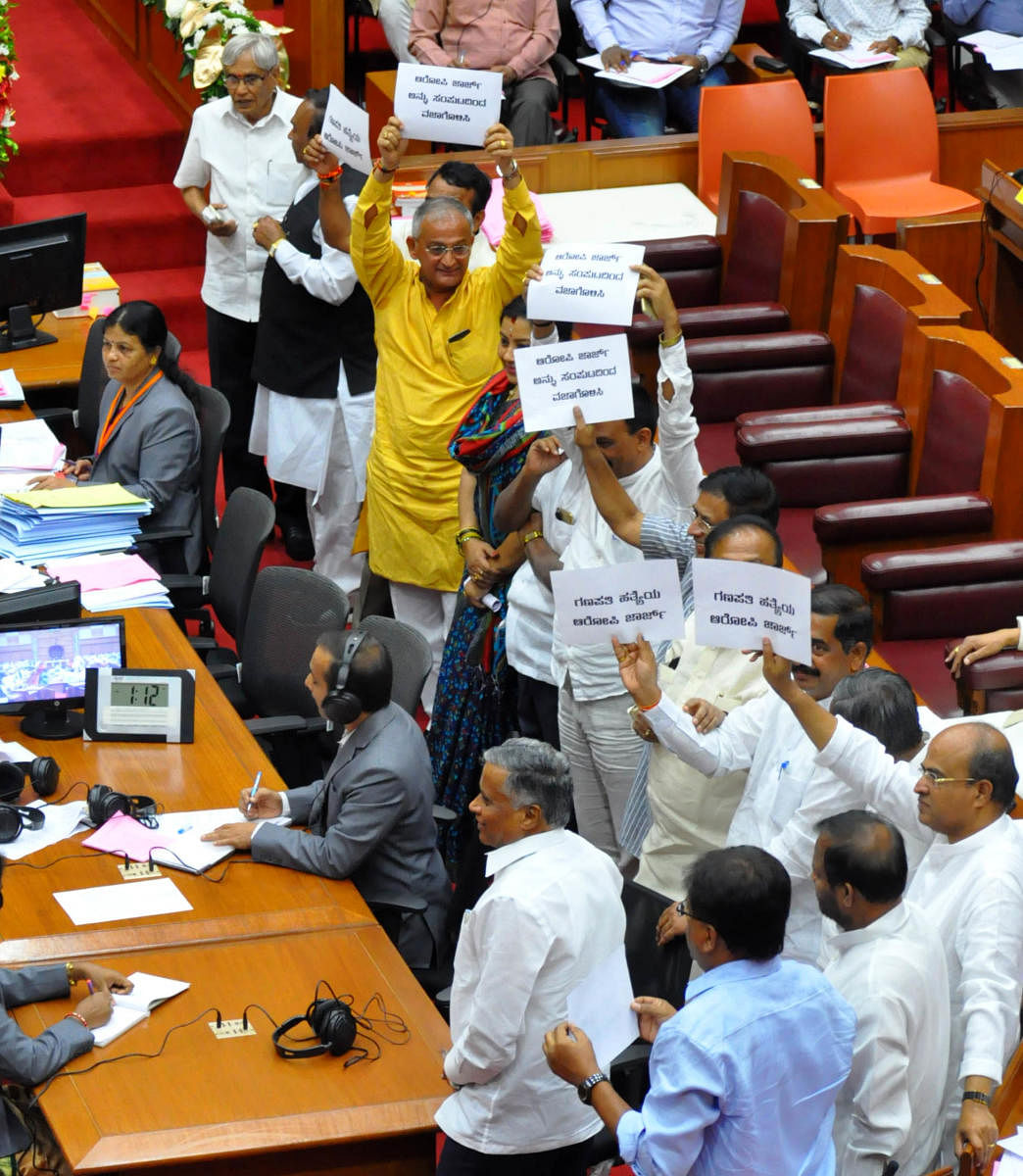 BJP members stage a protest in the Legislative Council, seeking resignation of Bengaluru Development Minister K J George during the winter session of the legislature that began in Belagavi on Monday. DH Photo.