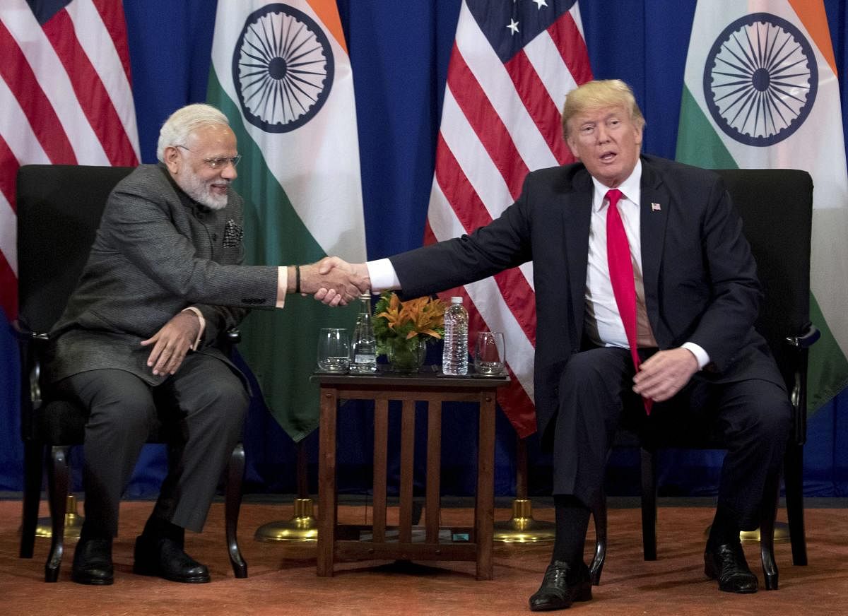 US President Donald Trump and Prime Minister Narendra Modi shake hands during a bilateral meeting at the ASEAN Summit at Manila in the Philippines on Monday. AP/PTI