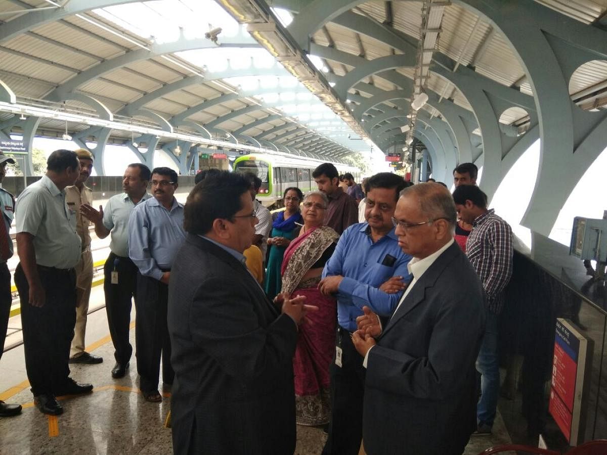 BMRCL Director (RSE and O&M) N M Dhoke (first from left), General Manager and PRO U A Vasanth Rao in conversation with Infosys co-founder N R Naryana Murthy at the RV Road Metro Station on Monday. DH photo