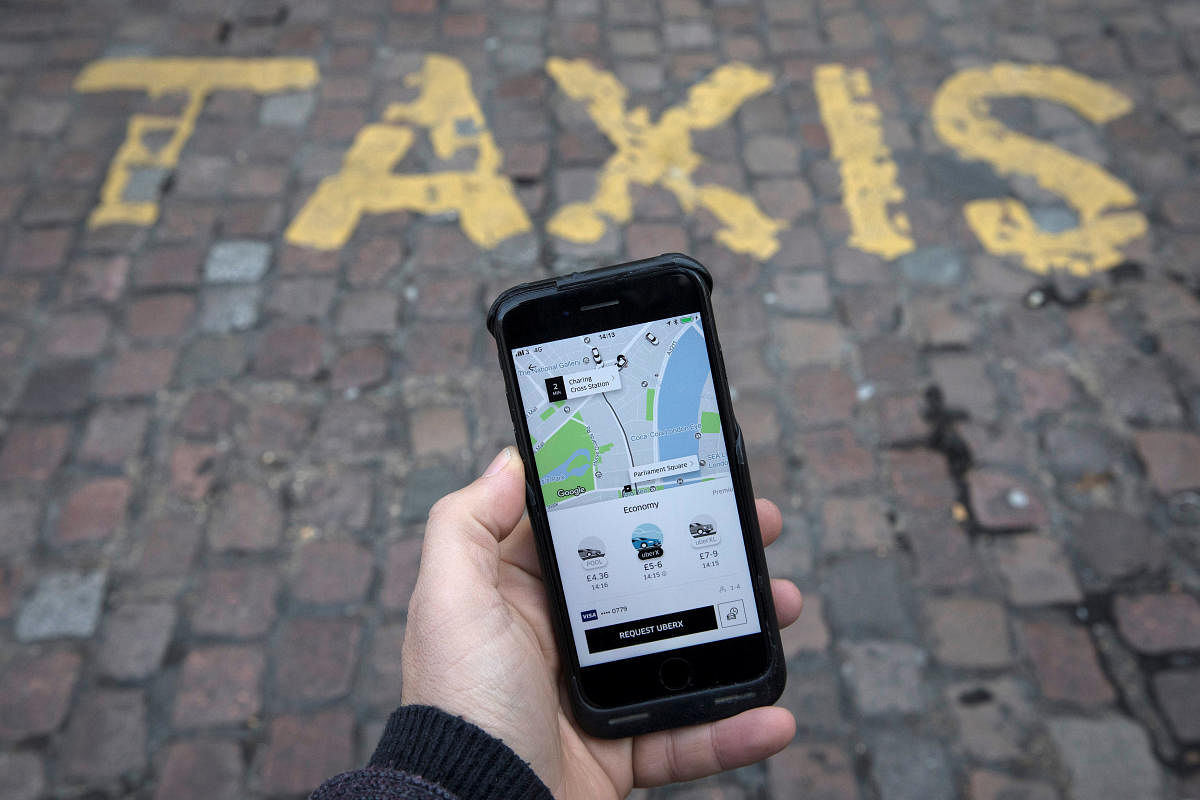 A photo illustration shows the Uber app on a mobile telephone, as it is held up for a posed photograph, in London, Britain November 10, 2017. REUTERS/Simon Dawson