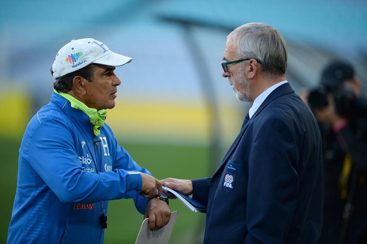 Time's up! Head coach of the Honduras national team Jorge Luis Pinto (left) complains to a FIFA official about media coverage of a football training session at the ANZ Stadium. AFP