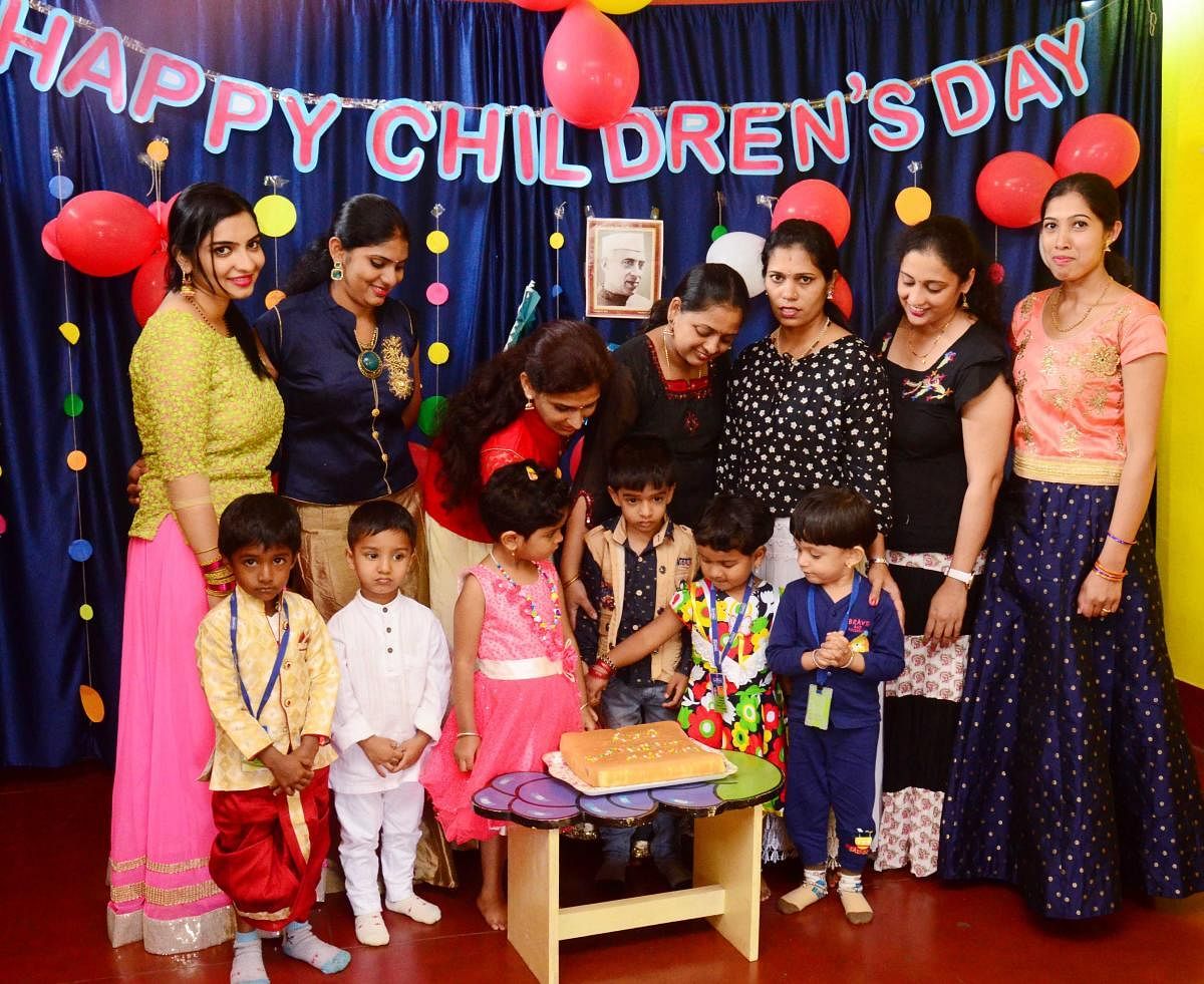14ko03Tiny tits cut a cake to celebrate children's day in Madikeri.
