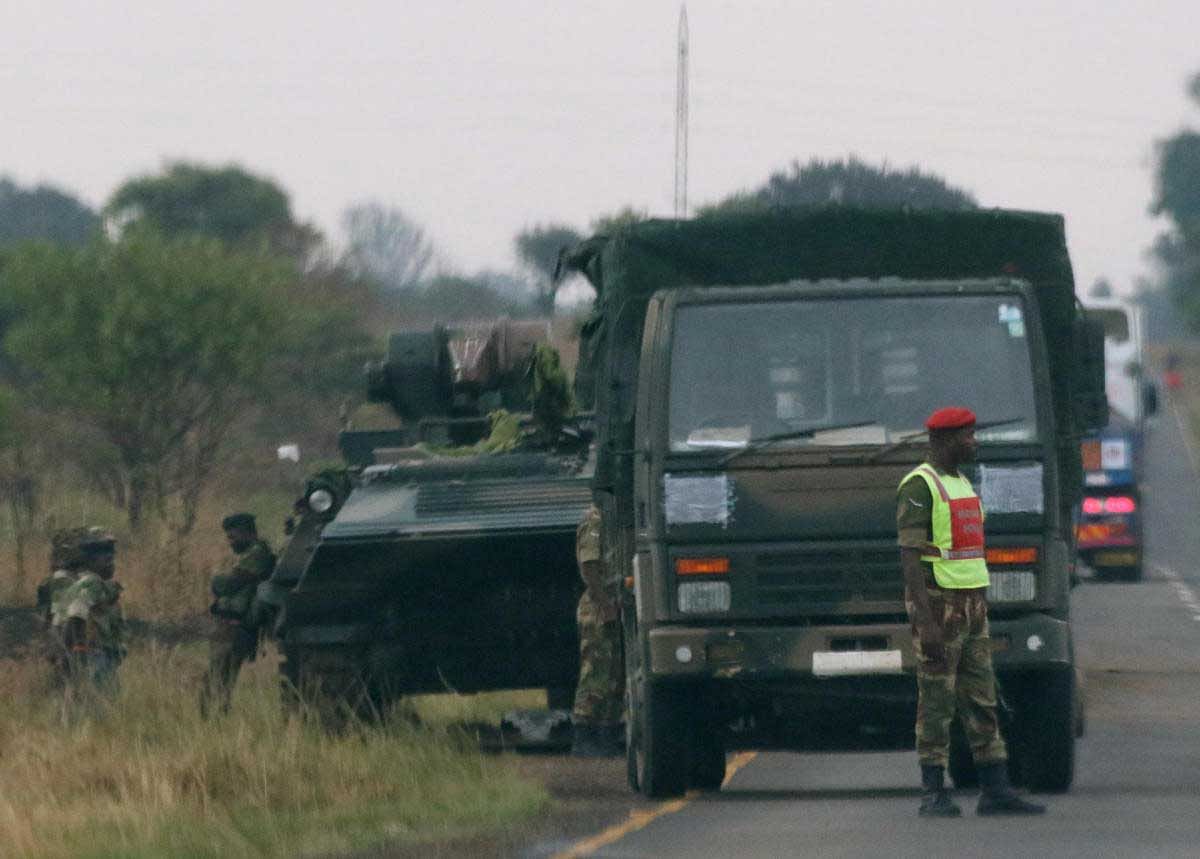 Soldiers stand beside military vehicles just outside Harare, Zimbabwe November 14, 2017. REUTERS