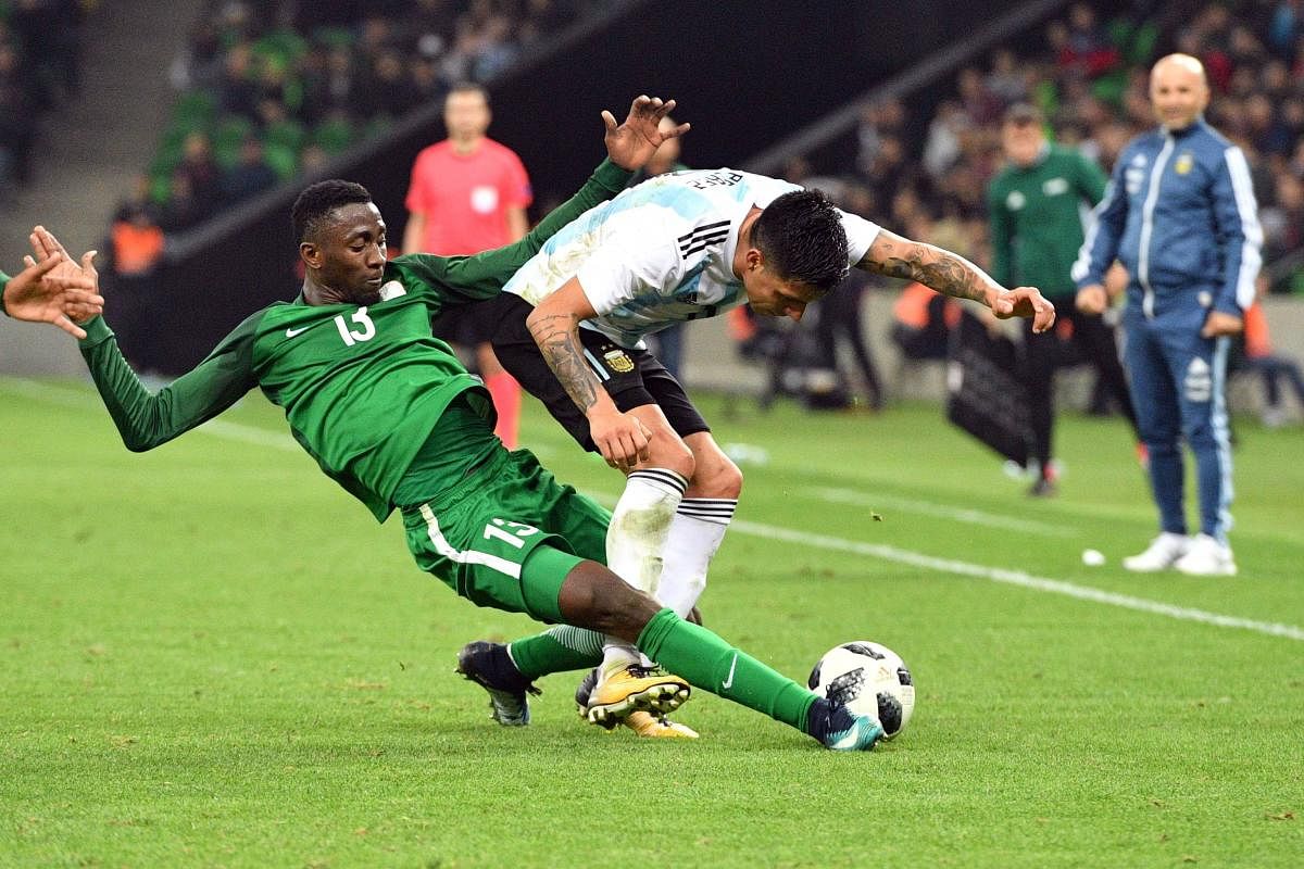 Nigeria's Onyinye Ndidi (left) tackles Enzo Perez of Argentina during their international friendly on Tuesday. AFP