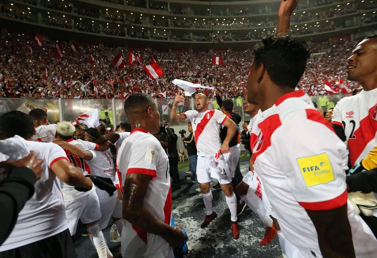Peruvian players celebrate after defeating New Zealand 2-0 to qualify for the 2018 football World Cup, in Lima, Peru, on Thursday. AFP